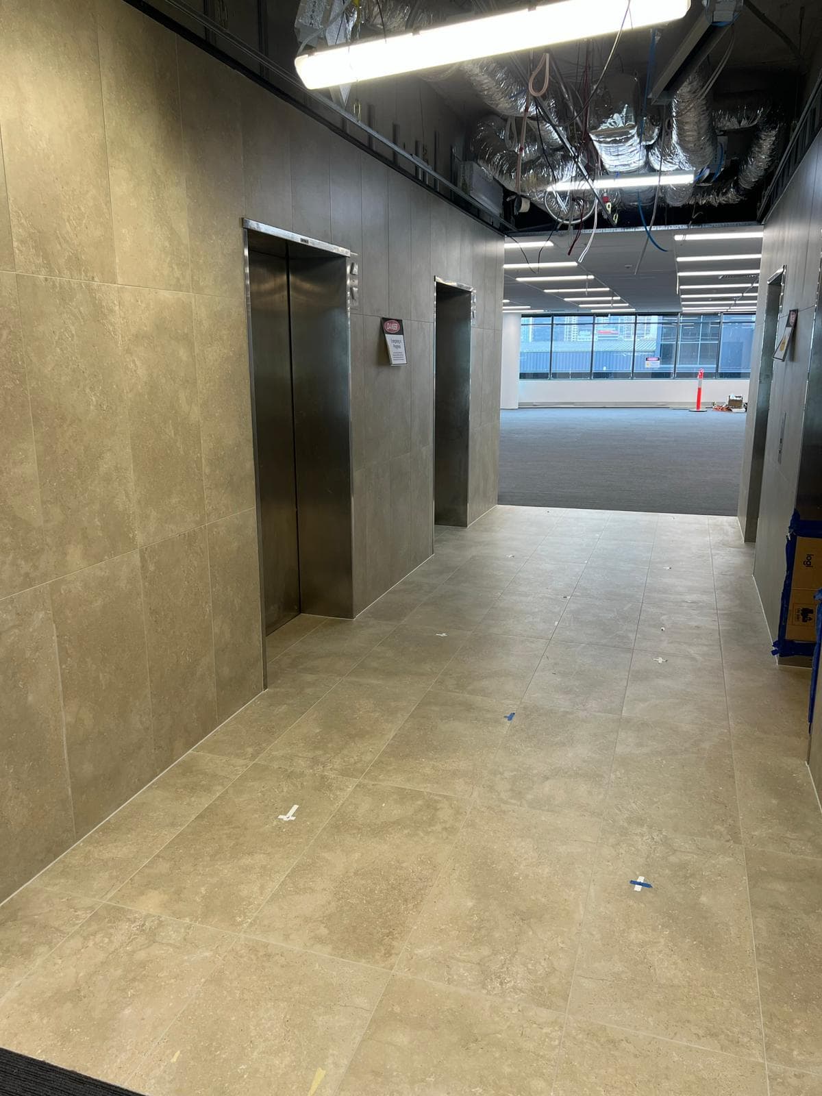 Tiled lift lobby and corridor in a commercial building