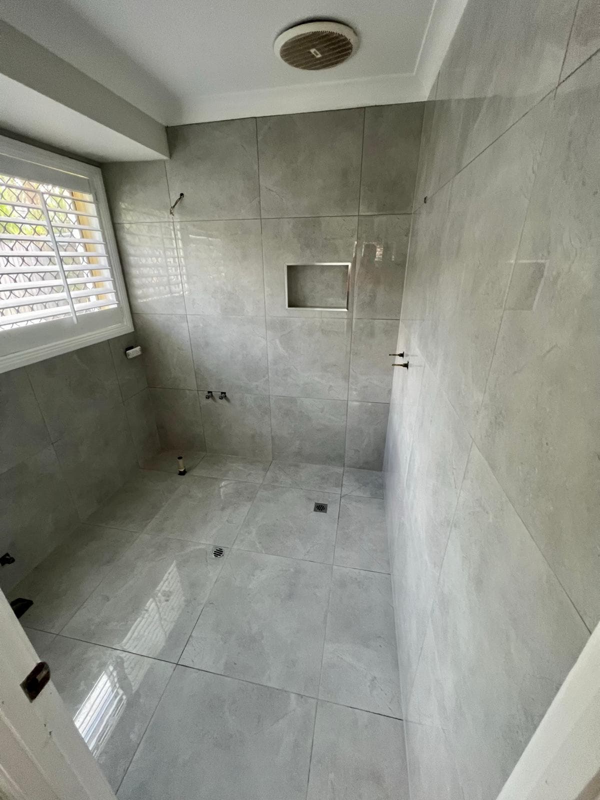Walk-in shower with wall and floor tile