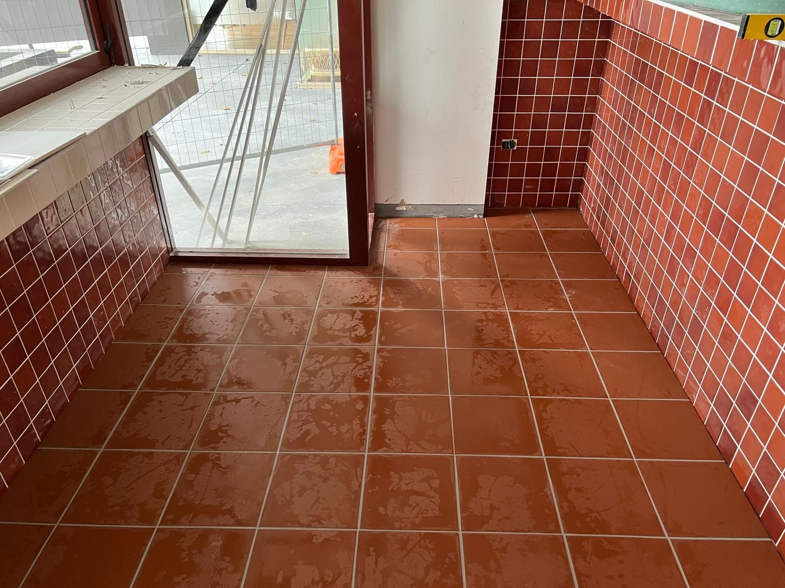 Commercial storefront opening onto a tiled mall walkway